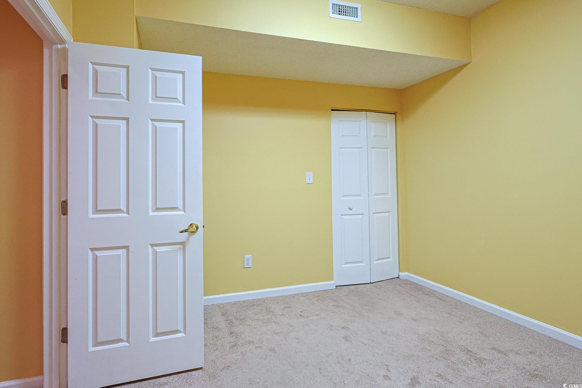 2302 Sweetwater Boulevard, Unit 2302 Murrells Inlet, SC 29576 - Photo 11 of 24 Unfurnished bedroom with light colored carpet and a closet