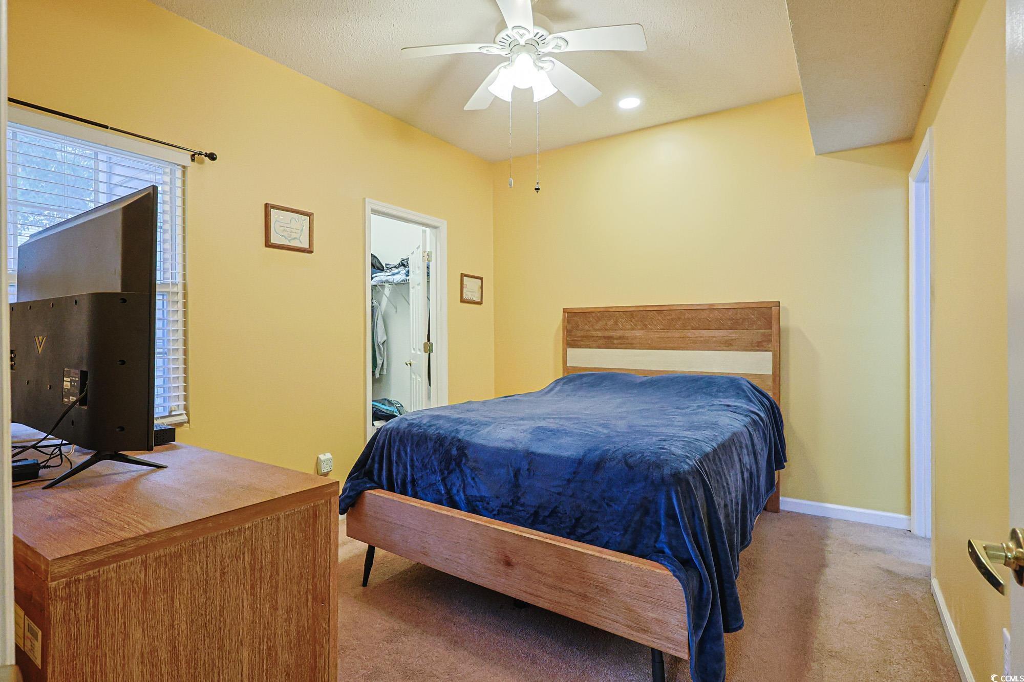 2302 Sweetwater Boulevard, Unit 2302 Murrells Inlet, SC 29576 - Photo 16 of 24 Bedroom featuring carpet flooring, ceiling fan, a walk in closet, and recessed lighting