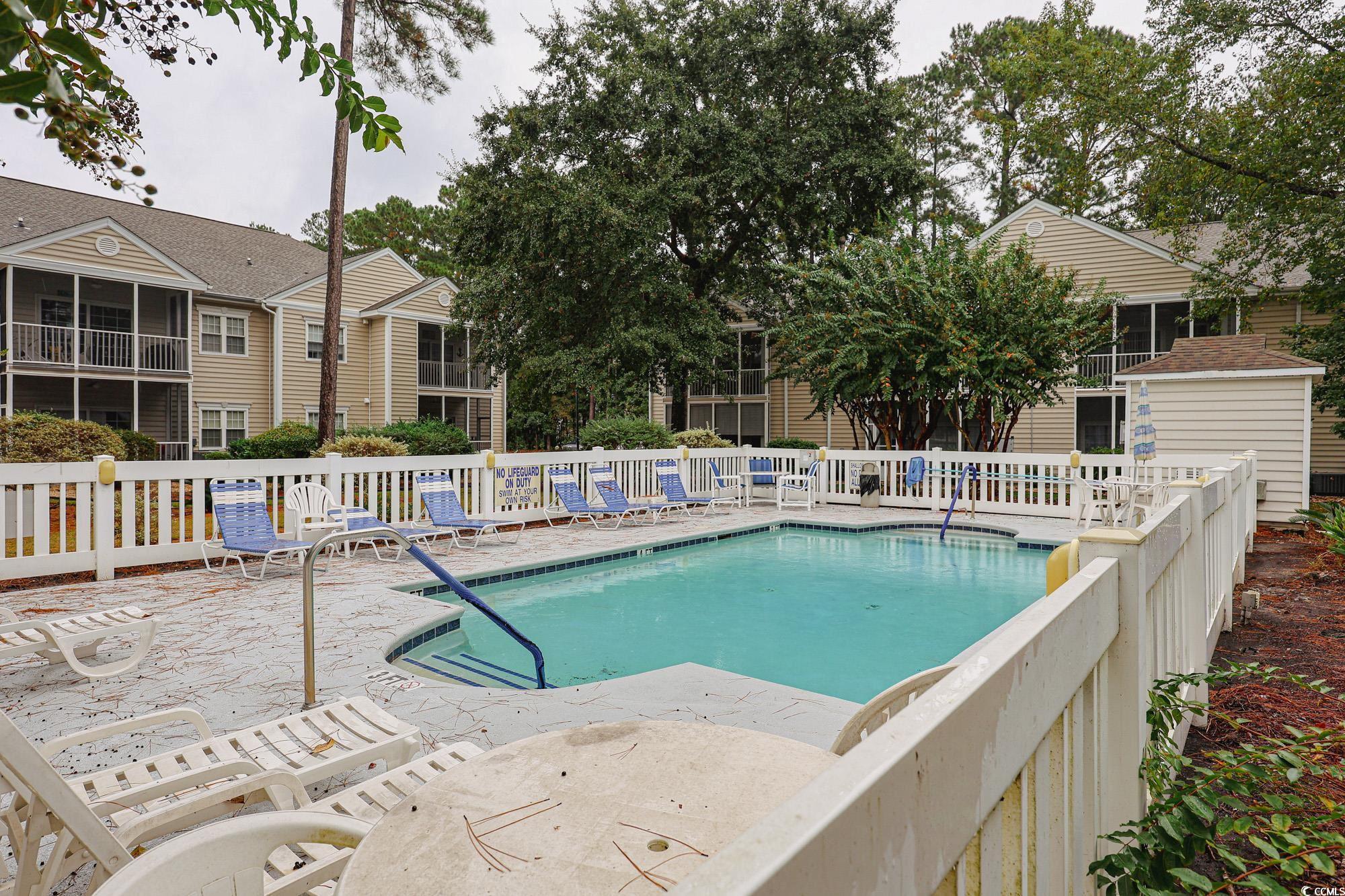 2302 Sweetwater Boulevard, Unit 2302 Murrells Inlet, SC 29576 - Photo 2 of 24 Community pool featuring a patio