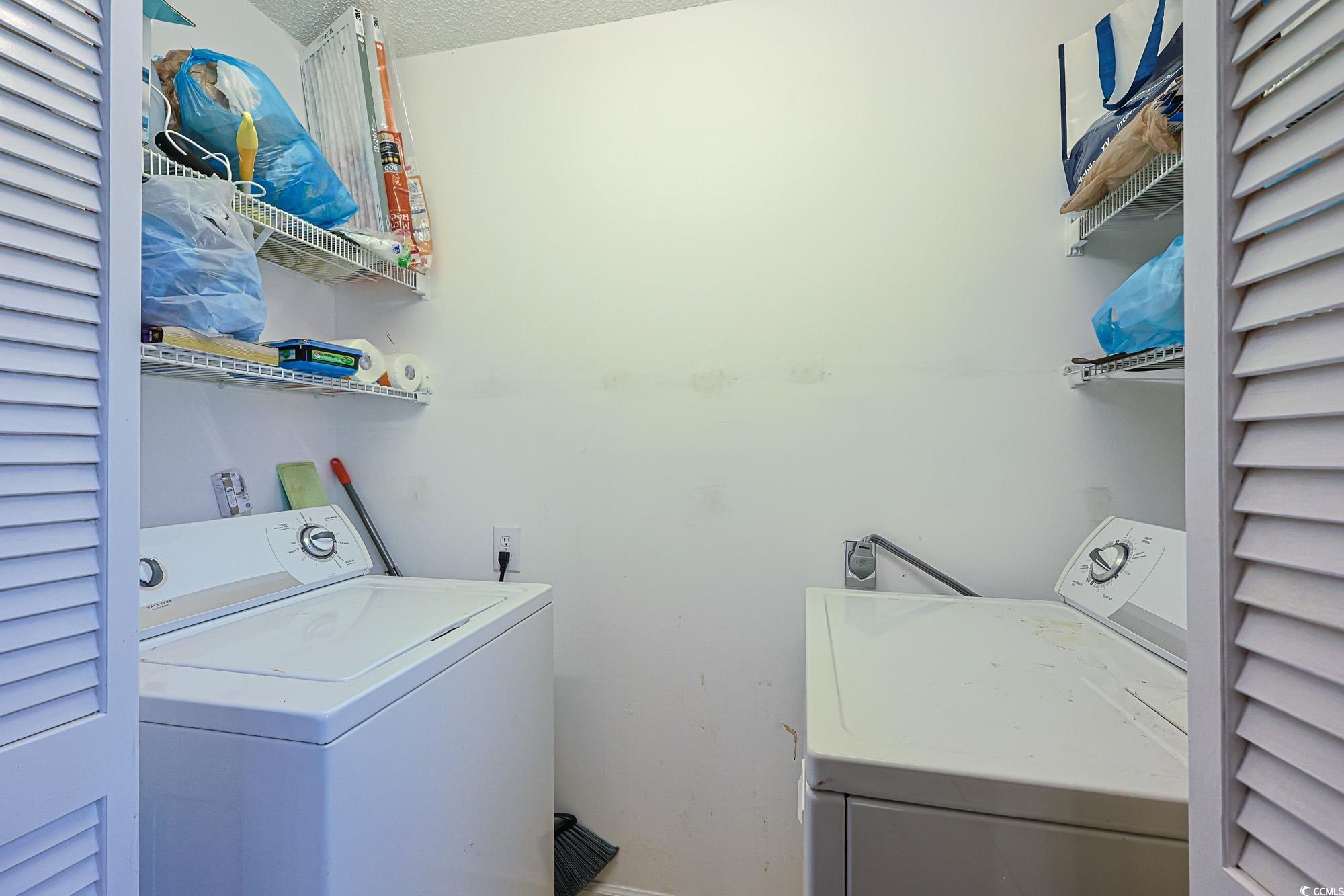 2302 Sweetwater Boulevard, Unit 2302 Murrells Inlet, SC 29576 - Photo 20 of 24 Washroom featuring independent washer and dryer and a textured ceiling