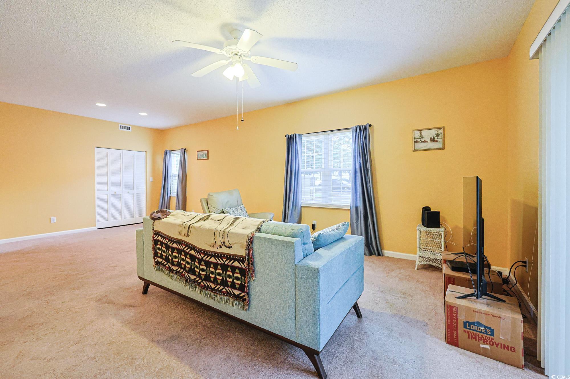 2302 Sweetwater Boulevard, Unit 2302 Murrells Inlet, SC 29576 - Photo 4 of 24 Living area with light carpet, a textured ceiling, ceiling fan, and recessed lighting