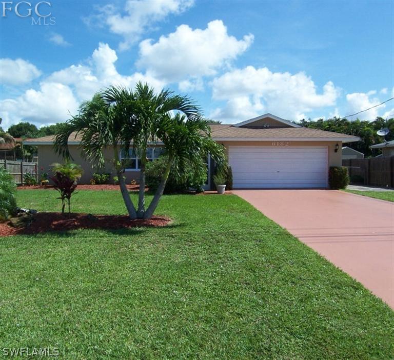 6182 Park Road Fort Myers, FL 33908 - Photo 1 of 15 a view of a house with a yard and a garden