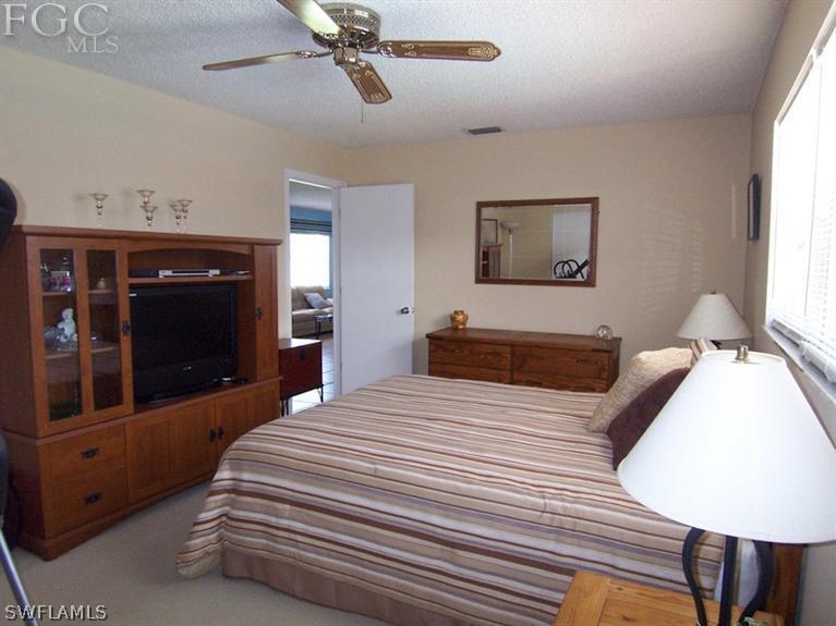 6182 Park Road Fort Myers, FL 33908 - Photo 8 of 15 a bedroom with a large bed and a flat tv screen