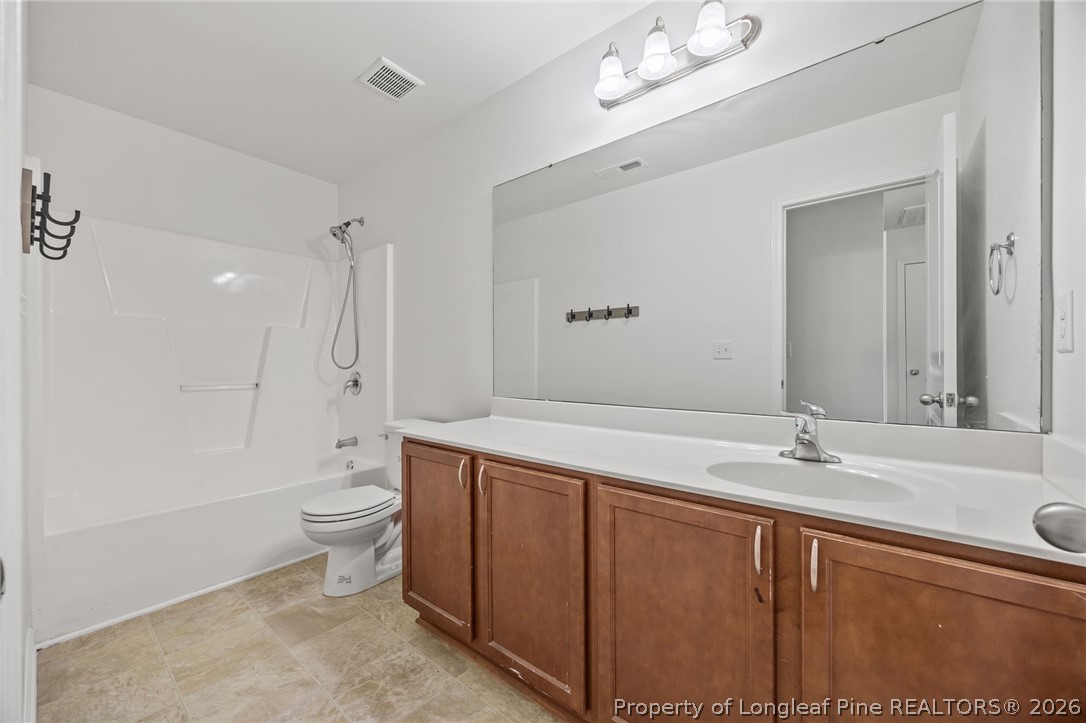 226 River Oak Street Spring Lake, NC 28390 - Photo 28 of 41 a bathroom with a sink a toilet and shower