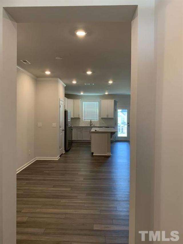 6518 Tremolo Trail, Unit C Raleigh, NC 27616 - Photo 3 of 8 a view of kitchen and hall with wooden floor