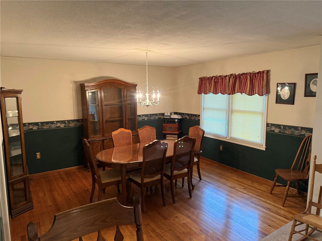 4027 Belhaven Road Belton, SC 29627 - Photo 8 of 24 Hardwood floors and ample natural light define this inviting dining area.