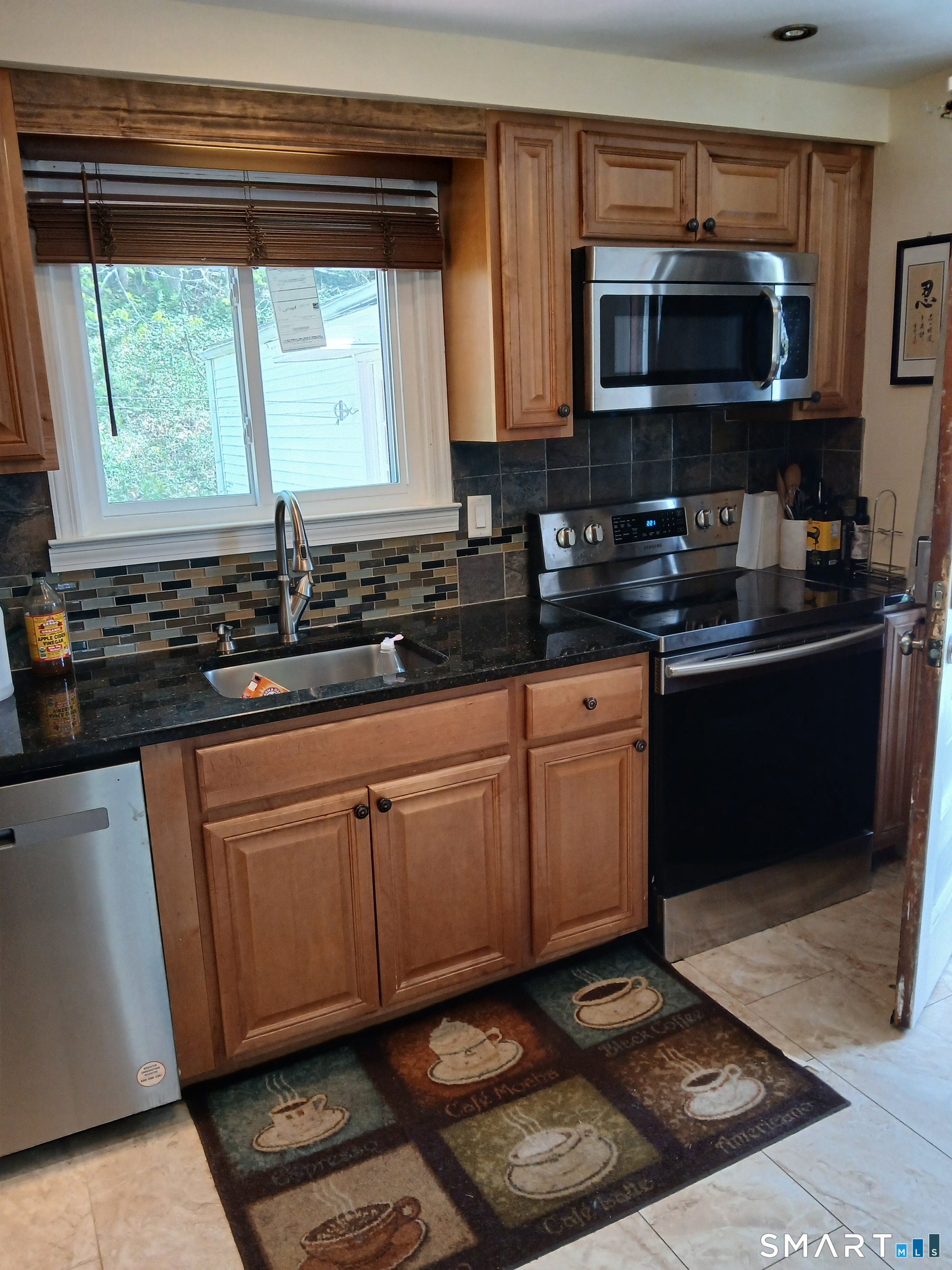 346 Lewis Road New Britain, CT 06053 - Photo 4 of 15 Kitchen Sink and Stove with side door to the right.