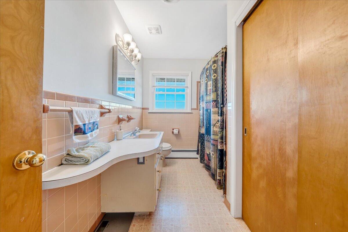 857 Olney Road Vinton, VA 24179 - Photo 11 of 45 a bathroom with a sink a mirror and a shower