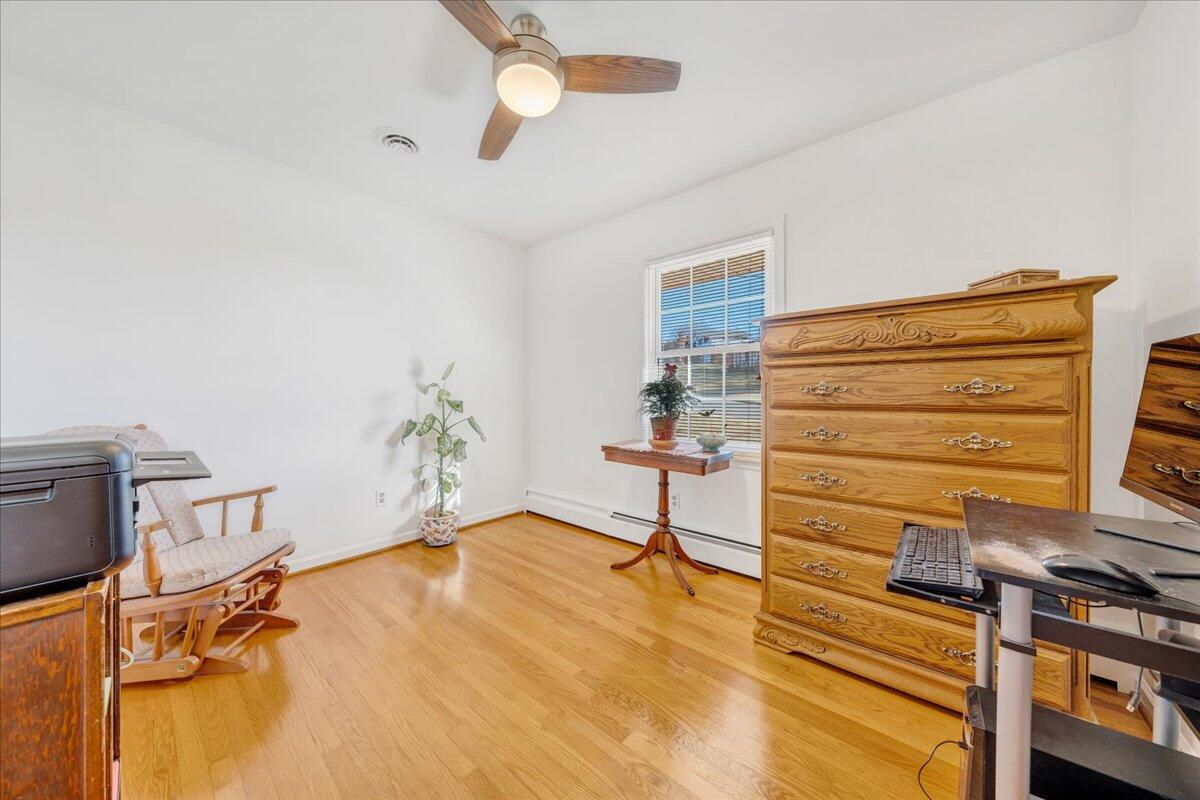 857 Olney Road Vinton, VA 24179 - Photo 12 of 45 a bedroom with a bed and a chandelier