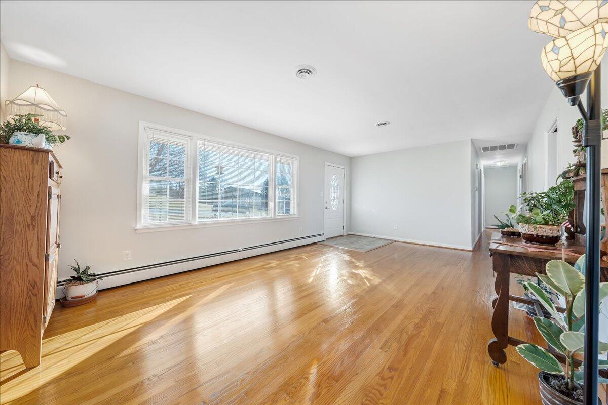 857 Olney Road Vinton, VA 24179 - Photo 5 of 45 a view of an empty room with a window and wooden floor