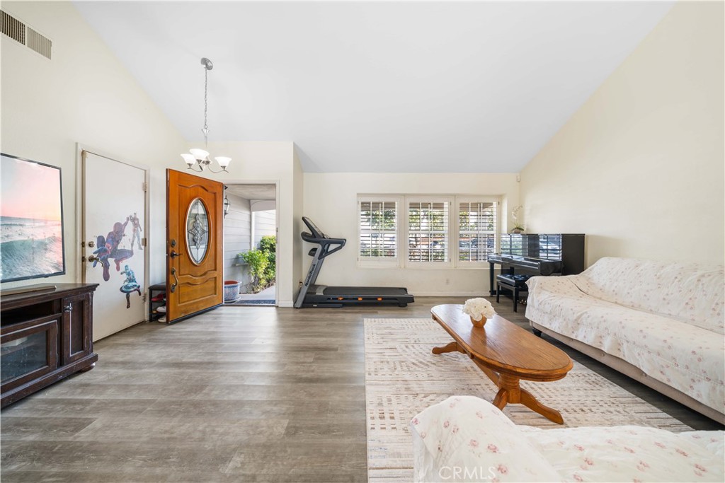 38 Carver Irvine, CA 92620 - Photo 11 of 55 a living room with furniture and a chandelier