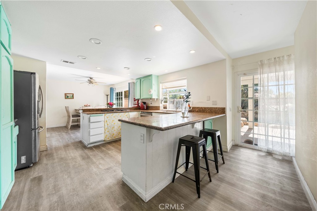 38 Carver Irvine, CA 92620 - Photo 20 of 55 a kitchen with stainless steel appliances a table chairs refrigerator and sink