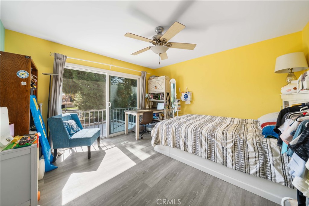 38 Carver Irvine, CA 92620 - Photo 38 of 55 a bedroom with a bed a couch and a flat tv screen on the dresser