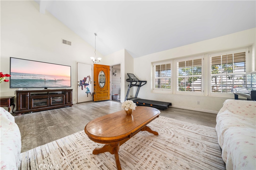 38 Carver Irvine, CA 92620 - Photo 9 of 55 a living room with furniture a flat screen tv and a large window