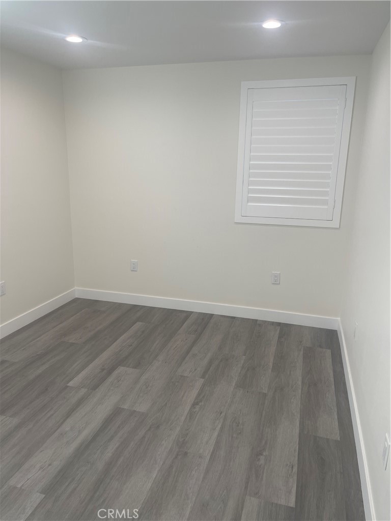 4656 Bell Place, Unit B Bell, CA 90201 - Photo 12 of 15 an empty room with wooden floor and windows