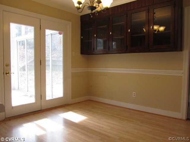 10819 Cherokee Road Midlothian, VA 23113 - Photo 11 of 24 a view of an empty room with wooden floor and a window