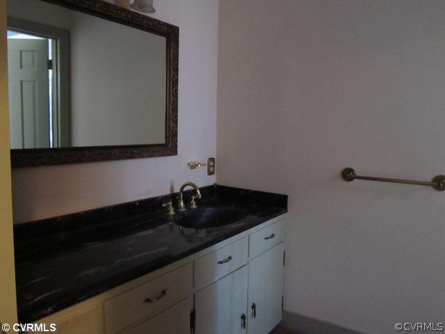 10819 Cherokee Road Midlothian, VA 23113 - Photo 14 of 24 a bathroom with a sink and a mirror