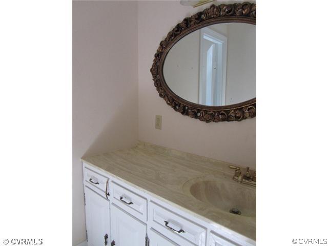 10819 Cherokee Road Midlothian, VA 23113 - Photo 18 of 24 a bathroom with a granite countertop sink and a mirror