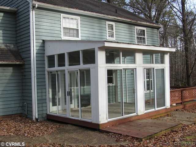 10819 Cherokee Road Midlothian, VA 23113 - Photo 20 of 24 a view of a brick house with large windows
