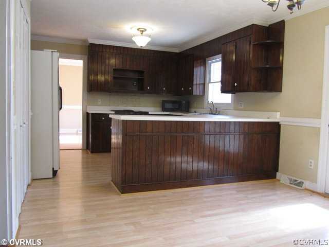 10819 Cherokee Road Midlothian, VA 23113 - Photo 10 of 24 a kitchen with stainless steel appliances granite countertop a stove a sink and a microwave