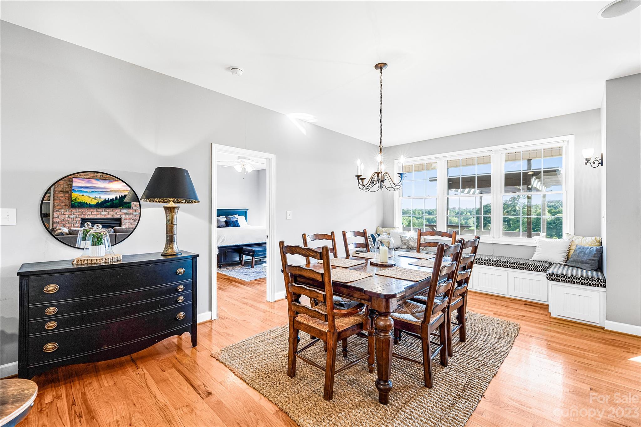 5423 Reepsville Road Vale, NC 28168 - Photo 13 of 48 a dining room with furniture a chandelier and wooden floor