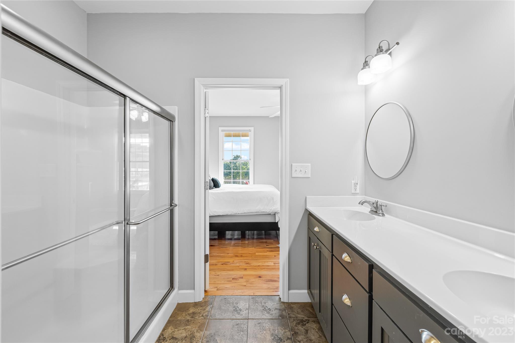5423 Reepsville Road Vale, NC 28168 - Photo 22 of 48 a en suite bathroom with a double vanity sink a mirror and shower