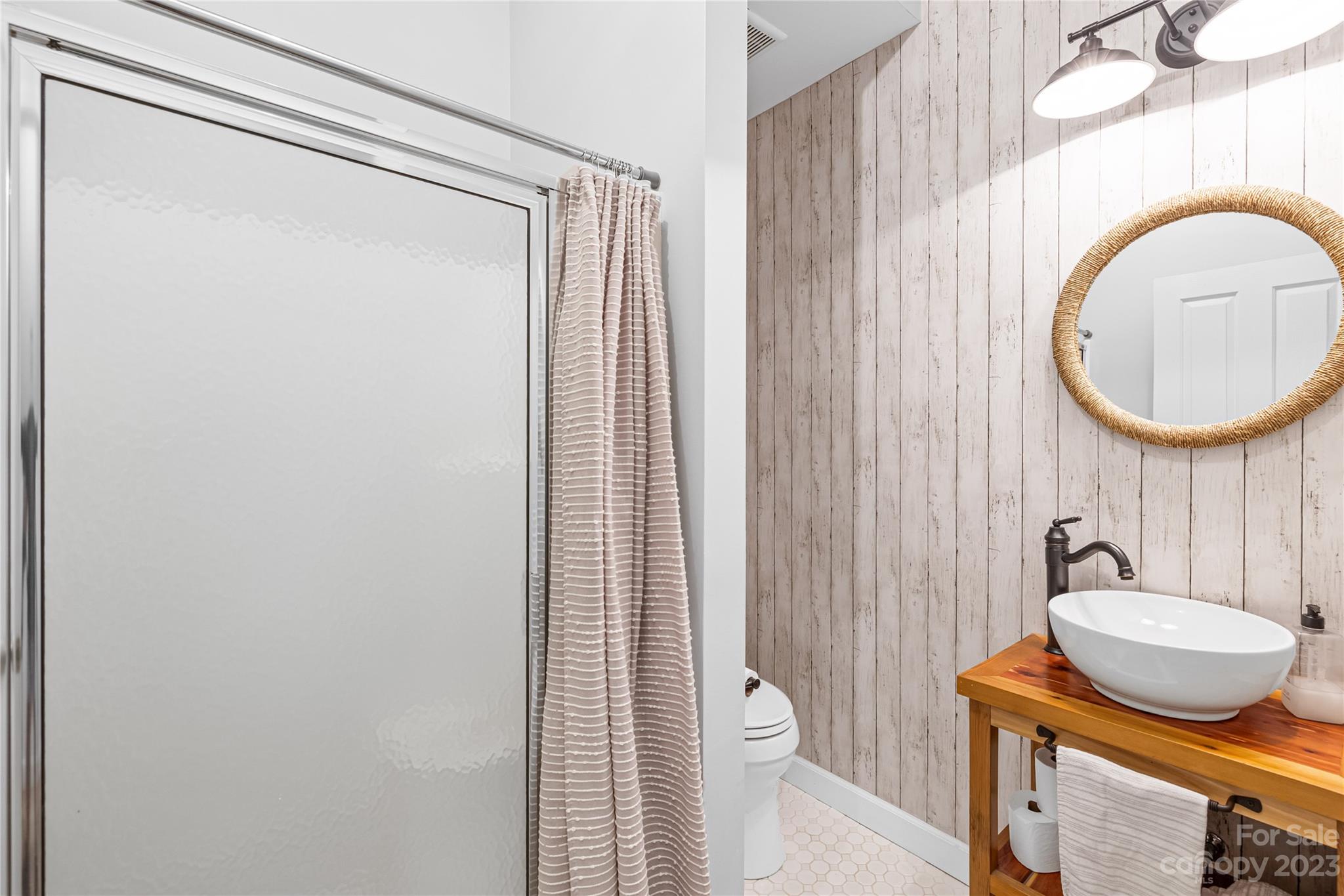 5423 Reepsville Road Vale, NC 28168 - Photo 25 of 48 a bathroom with a toilet a sink and a mirror