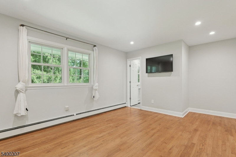 247 Spencer Road Bernards, NJ 07920 - Photo 11 of 48 a view of empty room with wooden floor and fan