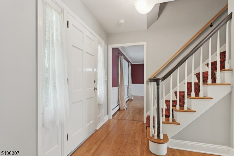 247 Spencer Road Bernards, NJ 07920 - Photo 17 of 48 a view of an entryway with wooden floor and staircase