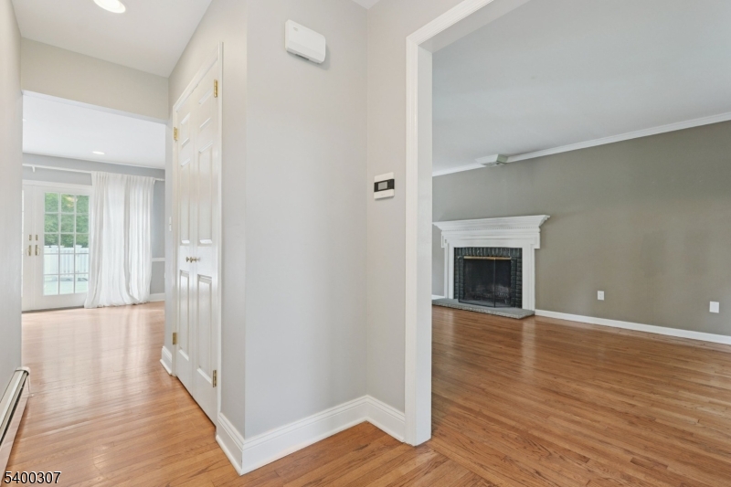 247 Spencer Road Bernards, NJ 07920 - Photo 18 of 48 a view of a hallway with wooden floor and a fireplace