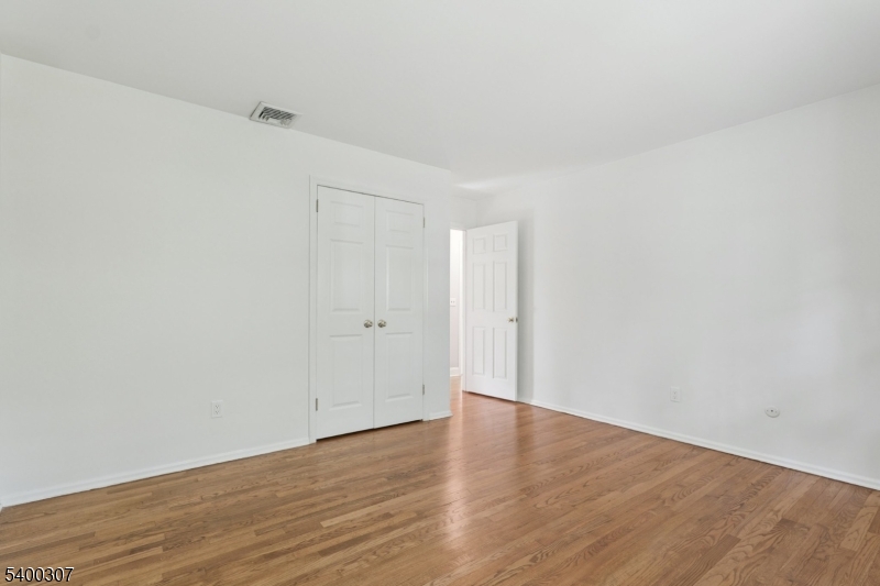 247 Spencer Road Bernards, NJ 07920 - Photo 27 of 48 a view of an empty room and wooden floor