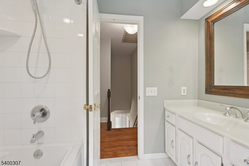 247 Spencer Road Bernards, NJ 07920 - Photo 28 of 48 a bathroom with a granite countertop sink a shower and a mirror