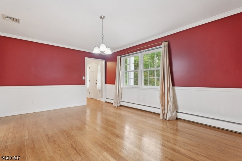 247 Spencer Road Bernards, NJ 07920 - Photo 38 of 48 a view of an empty room with wooden floor and a window