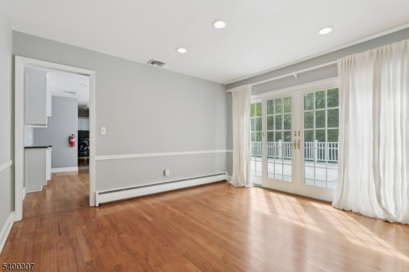247 Spencer Road Bernards, NJ 07920 - Photo 4 of 48 an empty room with wooden floor and windows