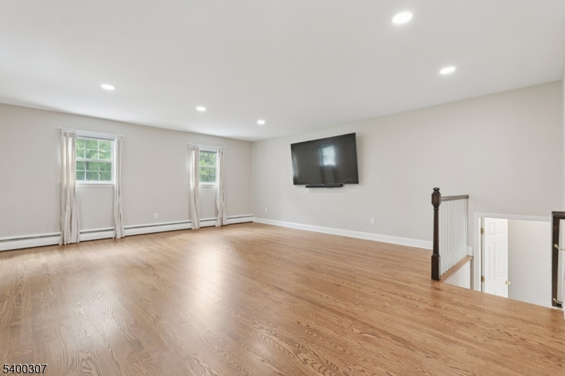 247 Spencer Road Bernards, NJ 07920 - Photo 41 of 48 a view of empty room with wooden floor and fan