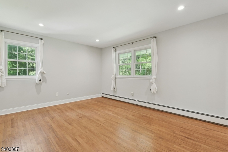 247 Spencer Road Bernards, NJ 07920 - Photo 42 of 48 an empty room with wooden floor and windows