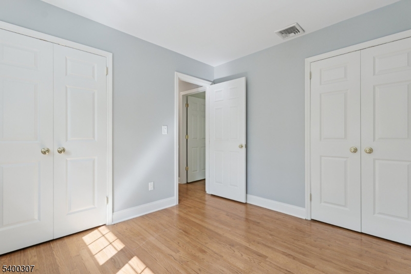247 Spencer Road Bernards, NJ 07920 - Photo 45 of 48 a view of an empty room and wooden floor