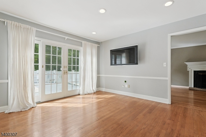 247 Spencer Road Bernards, NJ 07920 - Photo 5 of 48 a view of an empty room with a window and wooden floor