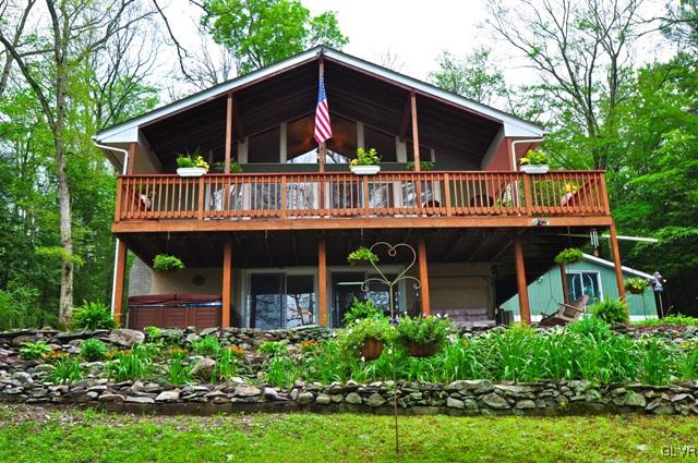 a view of a house with roof deck and garden