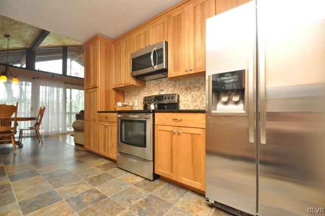 1251 Glenbrook Road Bartonsville, PA 18321 - Photo 11 of 37 a kitchen with stainless steel appliances granite countertop a stove a sink and a microwave