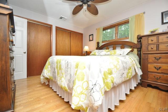 1251 Glenbrook Road Bartonsville, PA 18321 - Photo 14 of 37 a bedroom with a bed and a chandelier
