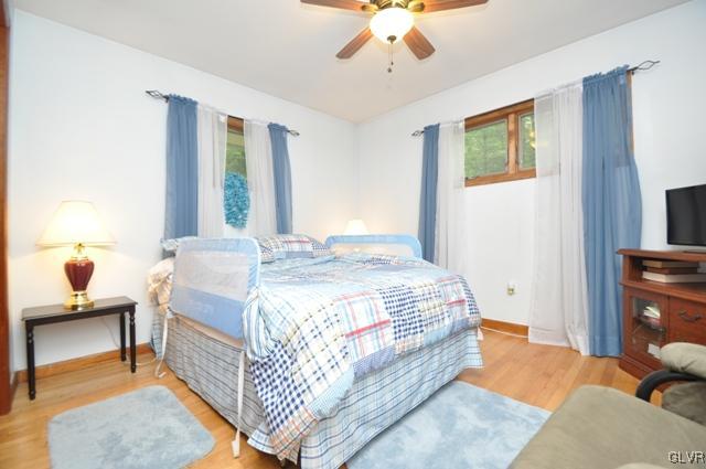 1251 Glenbrook Road Bartonsville, PA 18321 - Photo 15 of 37 a bedroom with a bed and a chandelier