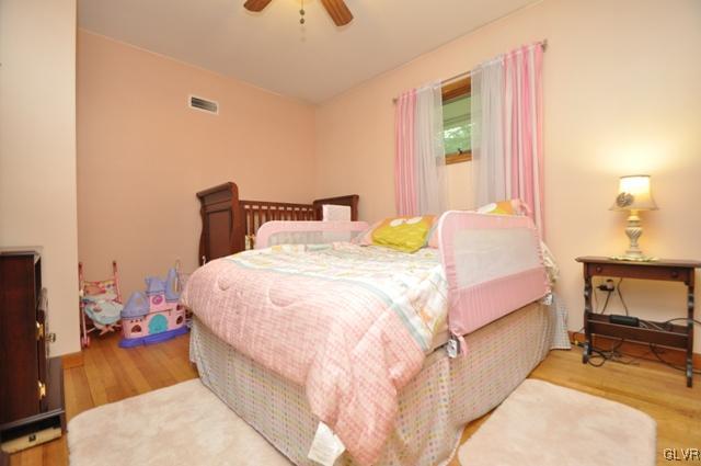 1251 Glenbrook Road Bartonsville, PA 18321 - Photo 16 of 37 a bedroom with a bed a chair and potted plant on the dresser