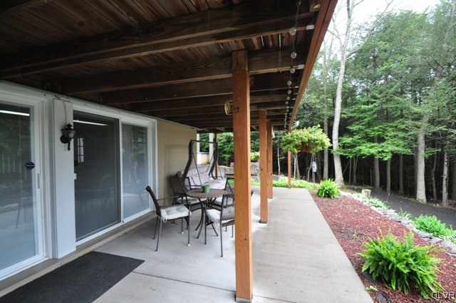 1251 Glenbrook Road Bartonsville, PA 18321 - Photo 36 of 37 a view of a porch with chairs and potted plants