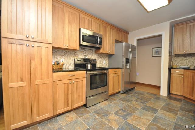 1251 Glenbrook Road Bartonsville, PA 18321 - Photo 7 of 37 a kitchen with stainless steel appliances granite countertop a stove a sink and a refrigerator