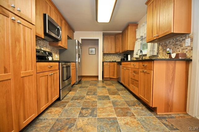 1251 Glenbrook Road Bartonsville, PA 18321 - Photo 9 of 37 a kitchen with stainless steel appliances granite countertop a refrigerator and a stove top oven