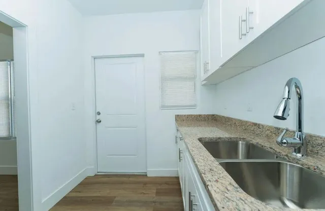 a kitchen with a sink and refrigerator