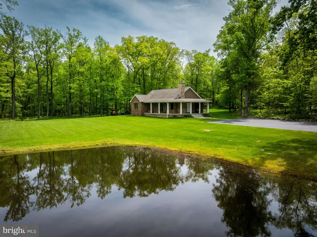 a front view of a house with a yard and garden