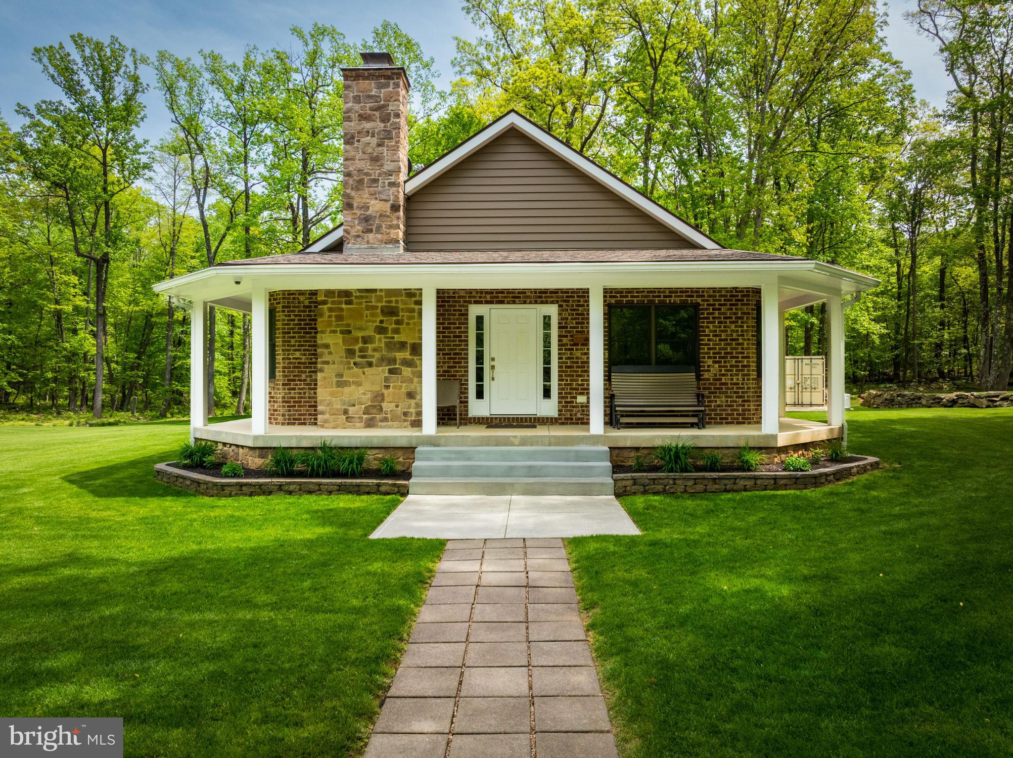 4740 Ford Fields Road Myersville, MD 21773 - Photo 2 of 147 a front view of a house with a yard and garden