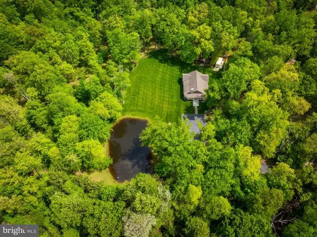 a bathroom with a granite countertop toilet sink and mirror